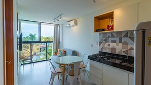 Una cucina moderna con zona pranzo, ampie finestre e un balcone.