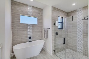 Bathtub, hair dryer, towels, soap