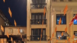 A hotel entrance with a grand facade, ornate balconies, and a well-lit interior. - Golden Legend Palace Hotel (Hanoi)