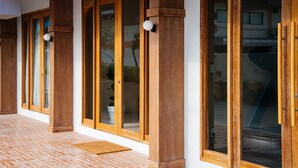 A building with wooden-framed glass doors and a tiled floor. - VST Punnawithi (Bangkok)