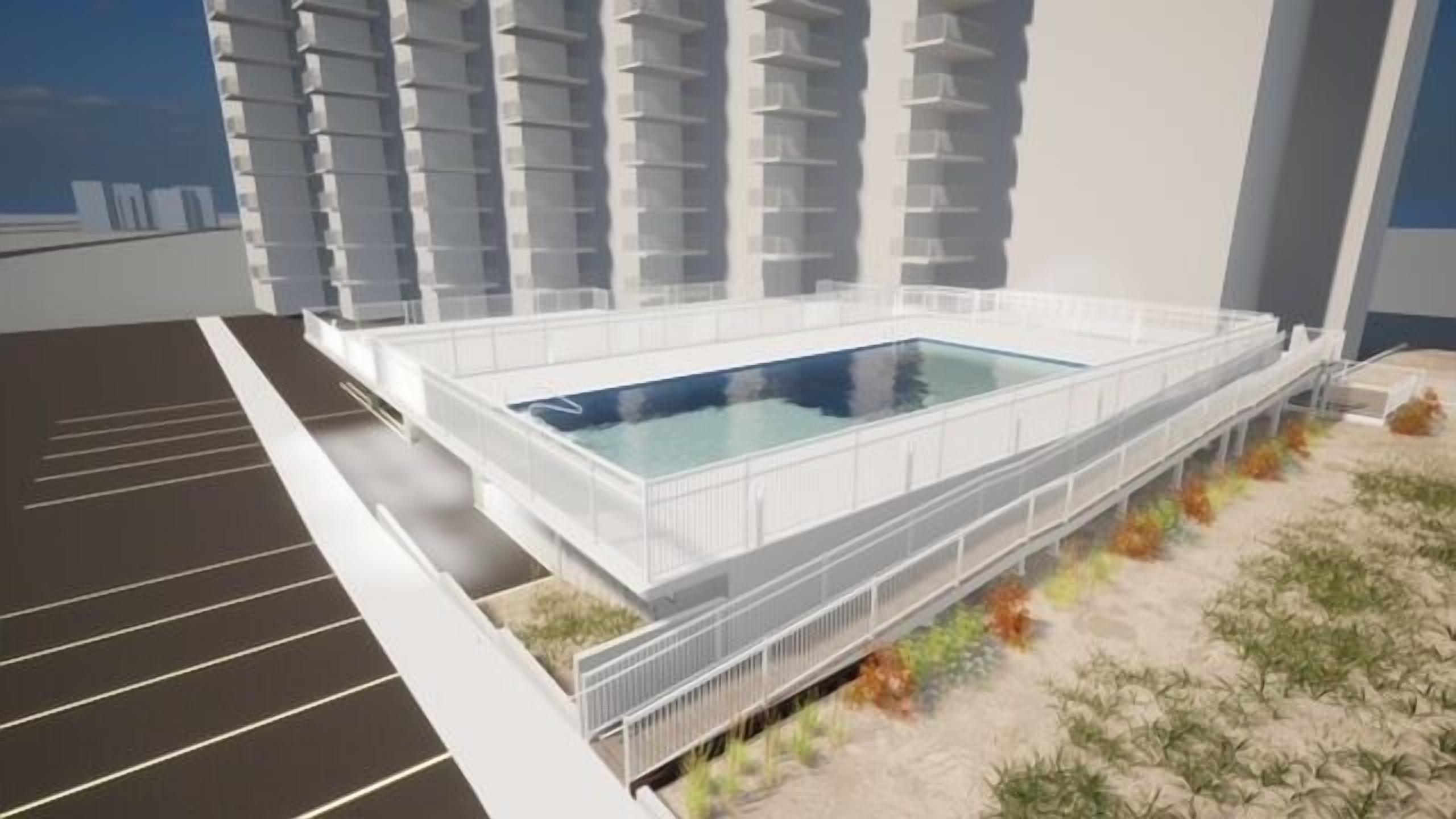 A modern building with a rectangular pool in the center, surrounded by a white fence.
