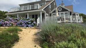 A large, two-story house with a covered porch and a fenced deck. - 600 Feet to Private Association Cape Cod Bay Beach (2266) (Eastham)