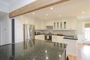 Enjoy cooking in this well-equipped kitchen with an oven, stainless steel appliances, and a spacious island with seating.