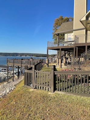 Enjoy waterfront views from the multi-level deck with stairs and a fence.