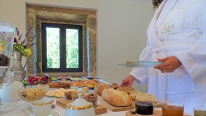 A breakfast buffet with various pastries, bread, and beverages. - Quinta da Roda - Nature and Wellness (Vila Verde)