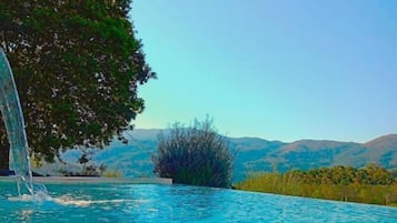 Outdoor pool, open 9:00 AM to 9:00 PM, pool umbrellas, pool loungers