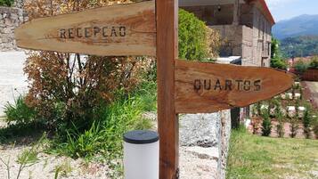 A wooden signpost with directions to 'Recepca' and 'Quartos'.