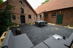 Enjoy dining or socializing in this tranquil patio area with a table and chairs.