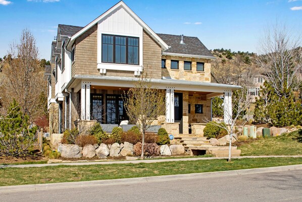A two-story house with a stone facade, a large front porch, and a garage. - Central Sundance location, steps to Sanitas trail and walk to downtown Boulder (Boulder)
