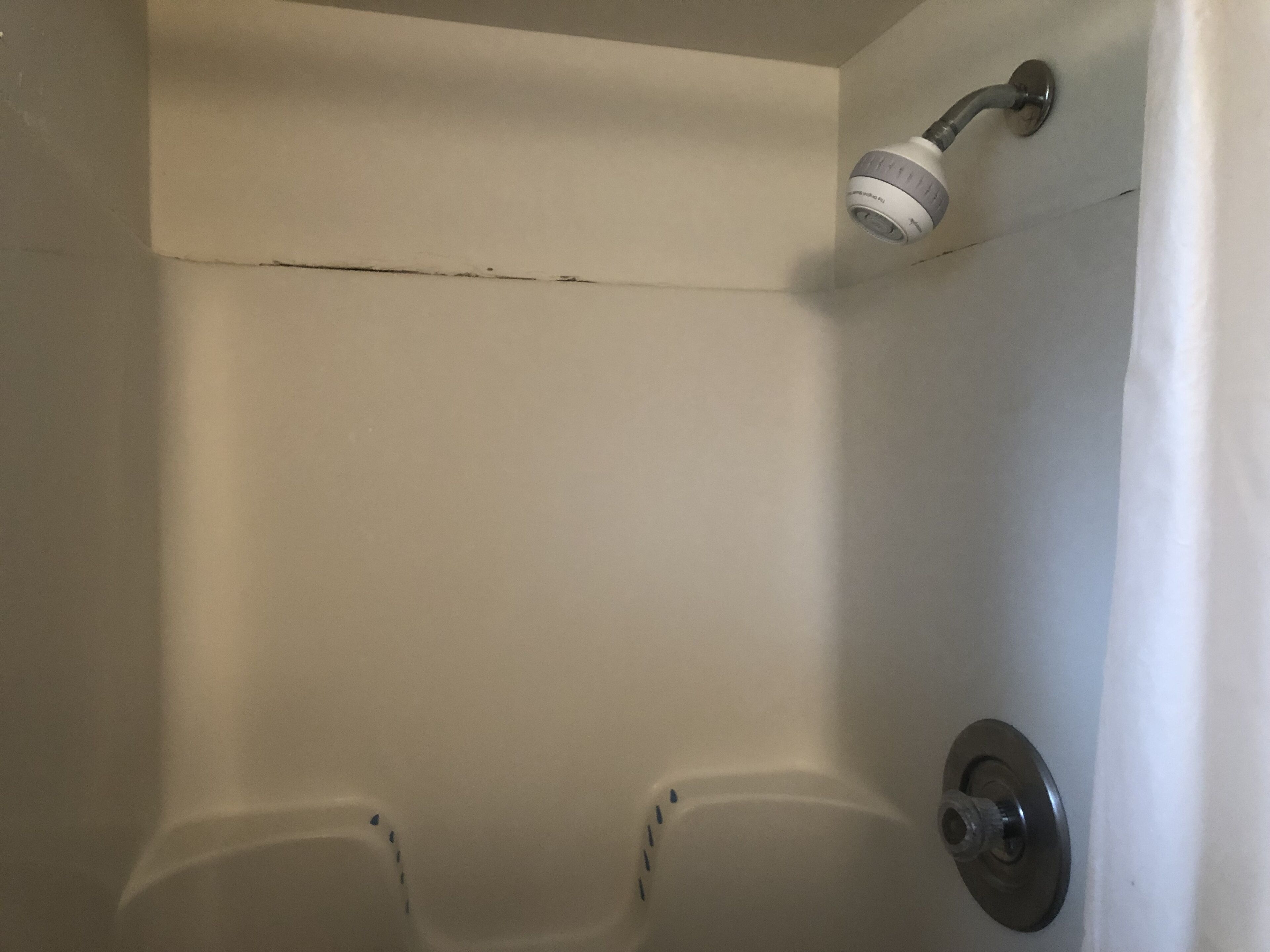 A bathtub with a showerhead and a faucet.