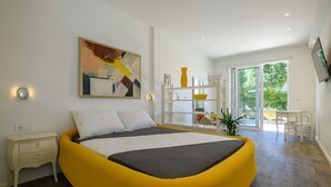 A modern bedroom with a large bed, bedside tables, a desk, and a large window. - ★FRAMAR apartment★ close to Old town, beach 300 m (Dubrovnik)
