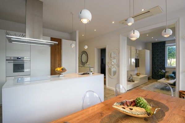 A modern kitchen with a central island, white cabinetry, and pendant lighting. - ★FRAMAR apartment★ close to Old town, beach 300 m (Dubrovnik)