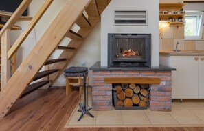 A modern kitchen with a fireplace, wooden staircase, and a small bar area. - Stunning home in Kunovac Kupirovacki with WiFi (Kunovac Kupirovacki)