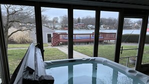 A hot tub with a view of a lake and houses in the background. - Waterfront home with dock, pool and hot tub! NOTRE DAME FOOTBALL (Osceola)