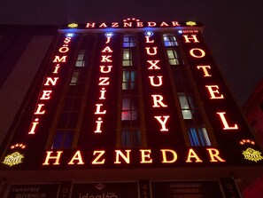 A hotel with illuminated signage spelling out "HAZNEDAR HOTEL" and "LUXURY" in large letters. - Haznedar Luxury Residence Hotel (Istanbul)