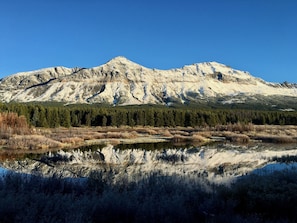 A mountain range with a clear reflection in a body of water.