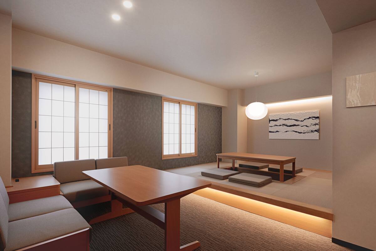 A modern interior with a wooden dining table, cushioned seating, and a low platform with steps.