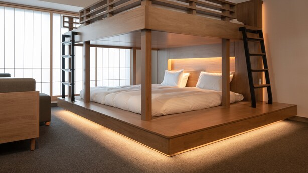 A bunk bed with a wooden frame and a ladder, a bedside table, and a chair. - MIMARU Tokyo Kinshicho (Tokyo)