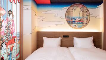 A hotel room with a bed, a wall mural, and a traditional Japanese artwork.