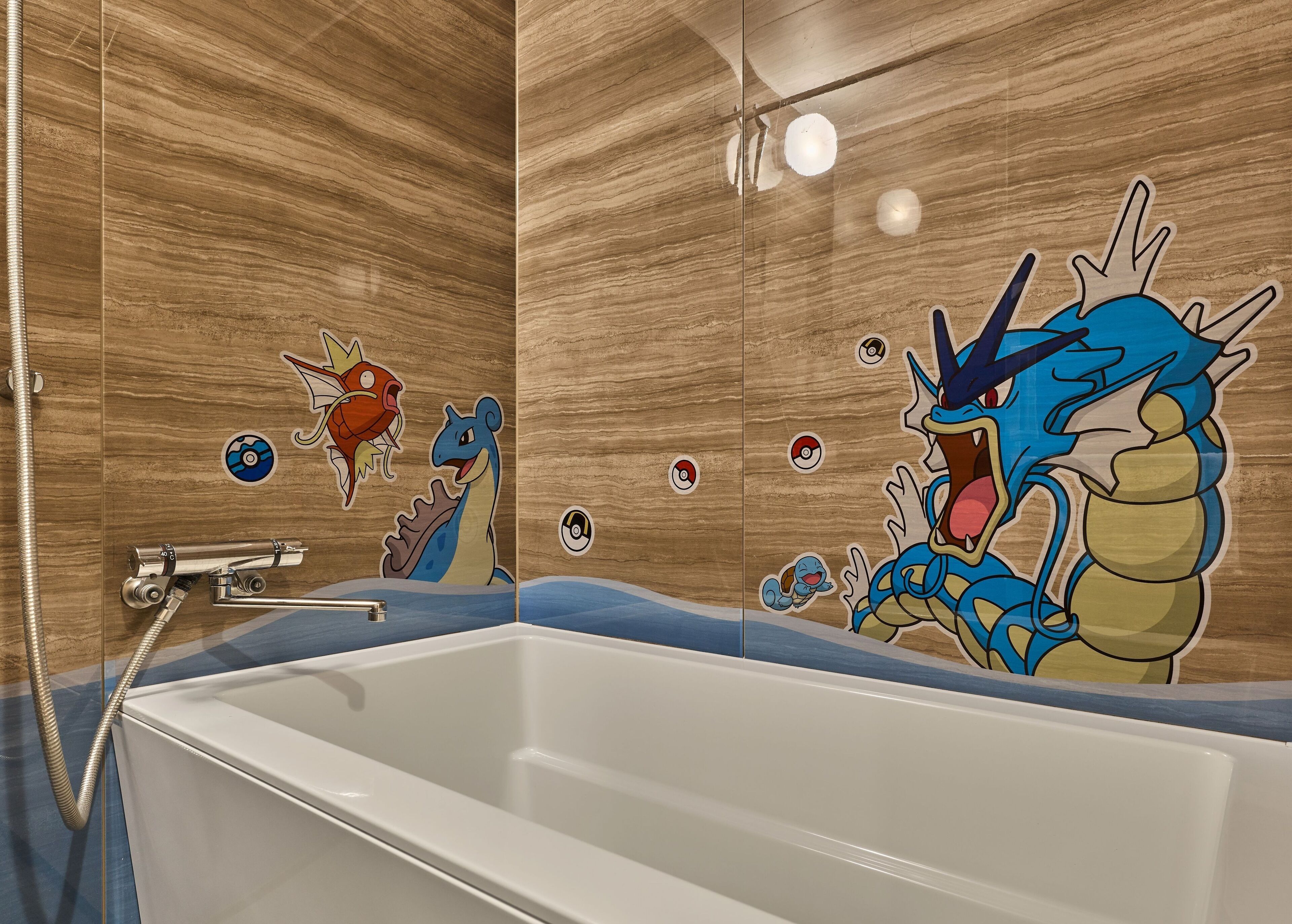 A bathtub with a Pokémon-themed wall decal.