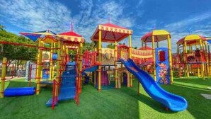 A playground with multiple play structures including slides and climbing areas. - Sarasota Gateway Beach House (Sarasota)