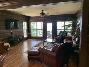 Relax in this inviting living room with a leather sofa, coffee table, and fireplace.