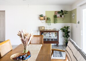Enjoy meals in this cozy dining area with a wooden table and wicker chairs, perfect for four.