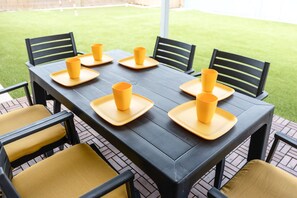 Enjoy al fresco dining on the patio with a beautifully set table for six.
