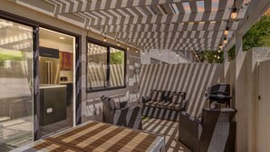 An outdoor patio with a pergola, seating area, and a grill. - ★Golf & Couples Oasis★ Midcentury w/6 Pools, Hot Tub (Palm Springs)