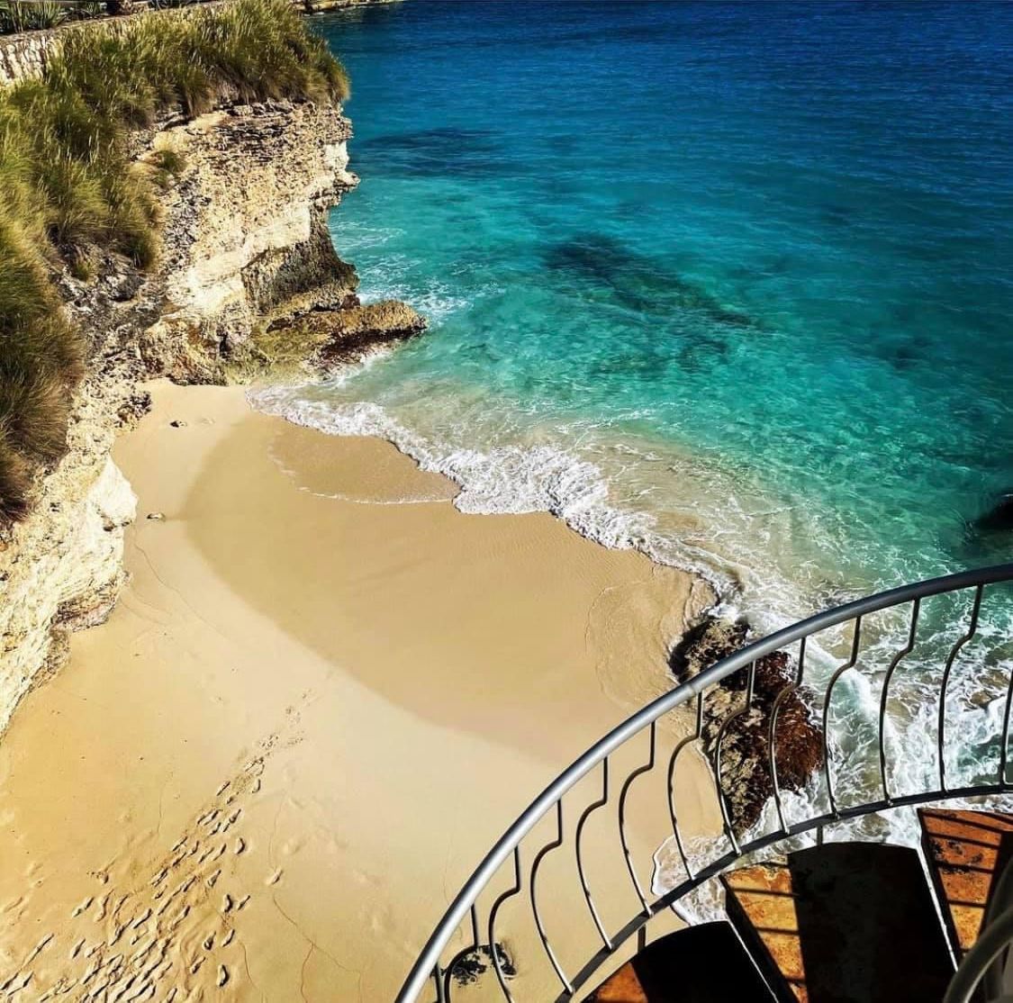 Private cove views with turquoise water and soft sandy beach
