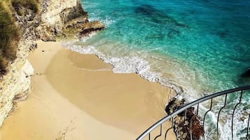 Private cove views with turquoise water and soft sandy beach