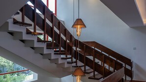 A modern staircase with wooden railings and pendant lights. - Hotel Boulevard Nairobi, City Centre CBD (Nairobi)