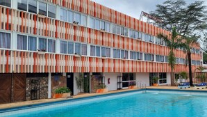 A hotel with a pool, multiple balconies, and a tropical garden. - Hotel Boulevard Nairobi, City Centre CBD (Nairobi)