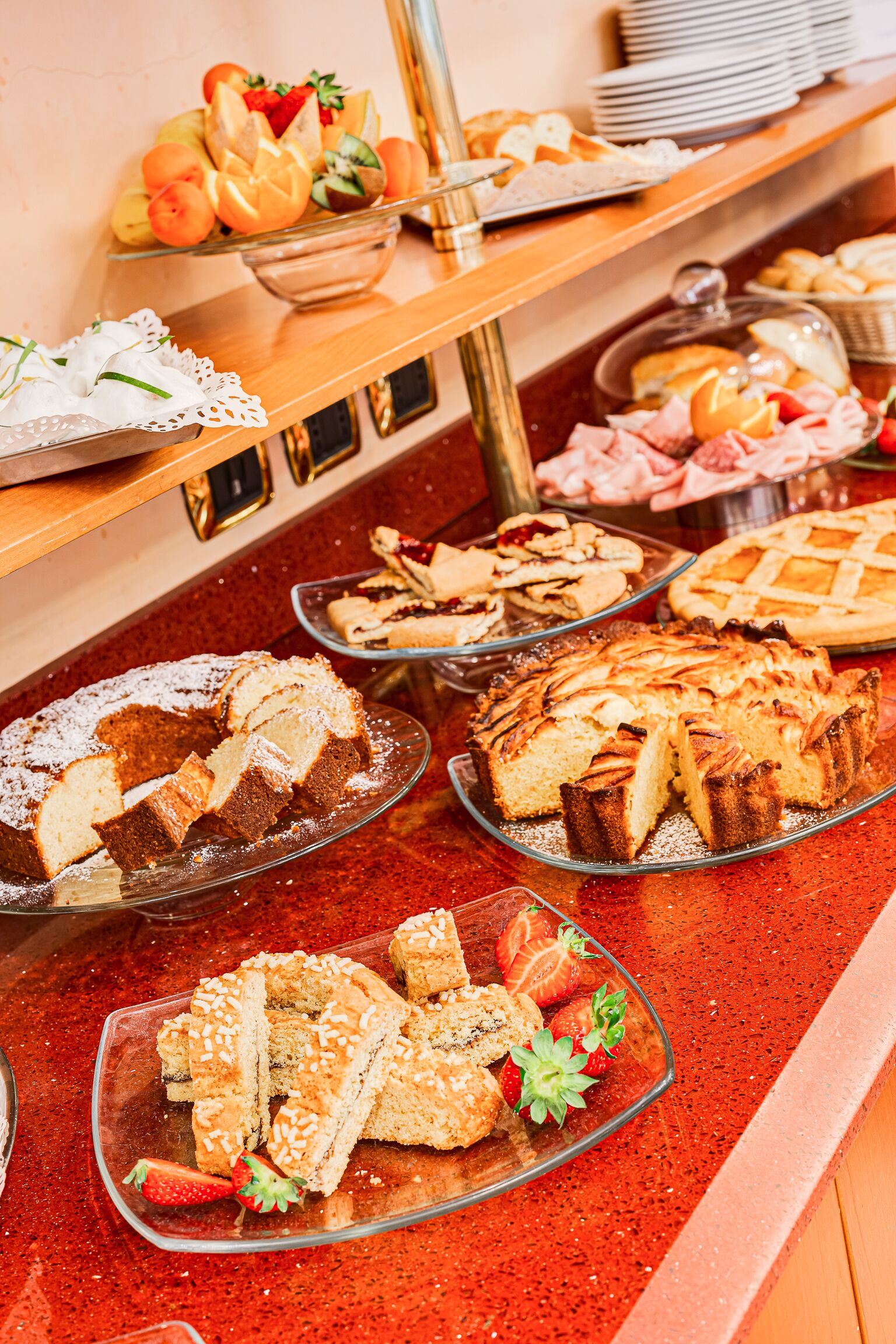 A buffet with various desserts and pastries.
