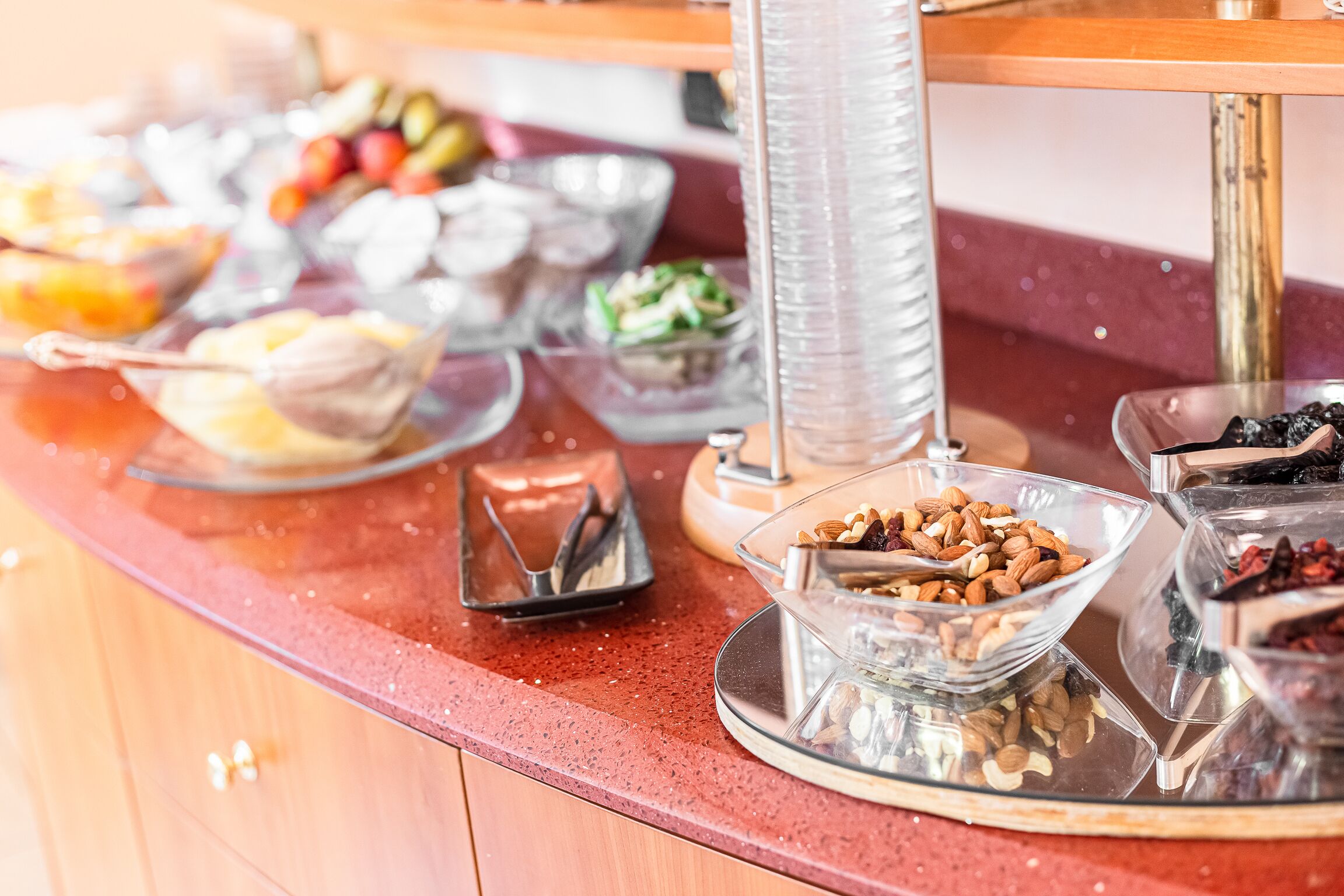 A buffet with various food items including fruits, nuts, and other snacks.