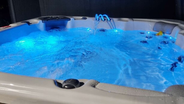 A hot tub with blue lighting and bubbles. - Beautifully  Presented One Bedroom Romantic Home & Private Hot Tub. (WEST LOOE)
