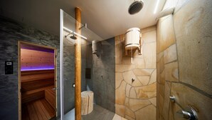 A modern bathroom with a stone wall, a wooden sauna, and a glass shower enclosure. - Radvanice Kcg351 in Radvanice (Radvanice)