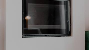 A wall-mounted television and a ventilation unit.