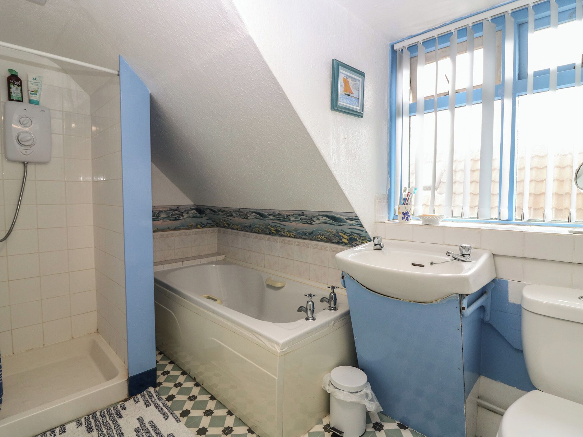 A bathroom with a bathtub, a sink, and a toilet.
