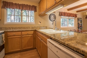 Kitchen features a sink, dishwasher, and ample natural light.