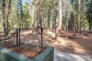 Enjoy a tranquil atmosphere surrounded by mature trees and access to picnic tables and a grill.