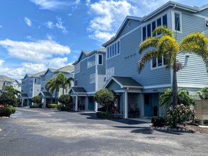A row of townhouses with a clear driveway and well-maintained landscaping.