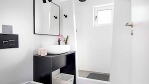 A modern bathroom with a white sink, black countertop, and a shower area. - Villa Paradiso Tria - Two Bedroom Villa, Sleeps 4 (Malevizi)