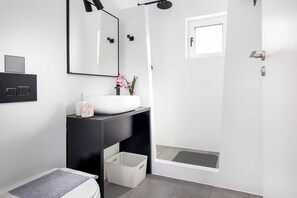 A modern bathroom with a white sink, black countertop, and a shower area. - Villa Paradiso Tria - Two Bedroom Villa, Sleeps 4 (Malevizi)