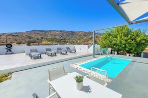 A rooftop pool area with lounge chairs, a table, and a view of a hilly landscape. - Villa Paradiso Tria - Two Bedroom Villa, Sleeps 4 (Malevizi)