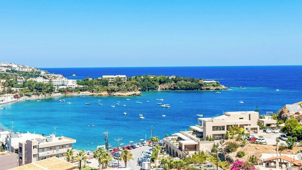 A coastal town with buildings, a marina, and clear blue waters. - Villa Paradiso Tria - Two Bedroom Villa, Sleeps 4 (Malevizi)