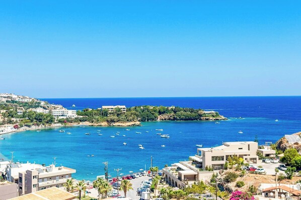 A coastal town with buildings, a marina, and clear blue waters. - Villa Paradiso Tria - Two Bedroom Villa, Sleeps 4 (Malevizi)