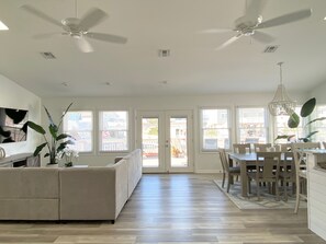 Relax in this spacious living area with a large L-shaped sofa and dining table.