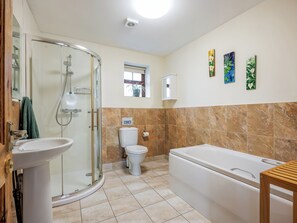 A bathroom with a glass-enclosed shower, a sink, a toilet, and a bathtub. - Robins Nest - UK36322 (Holly Hedge Farm)