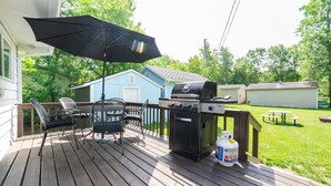 A wooden deck with a grill, chairs, and an umbrella. - 🏖 Sandy Hook: 2 Queens, Pet Friendly, One Min to Beach, Ice Fishing and Snaks (Sandy Hook)